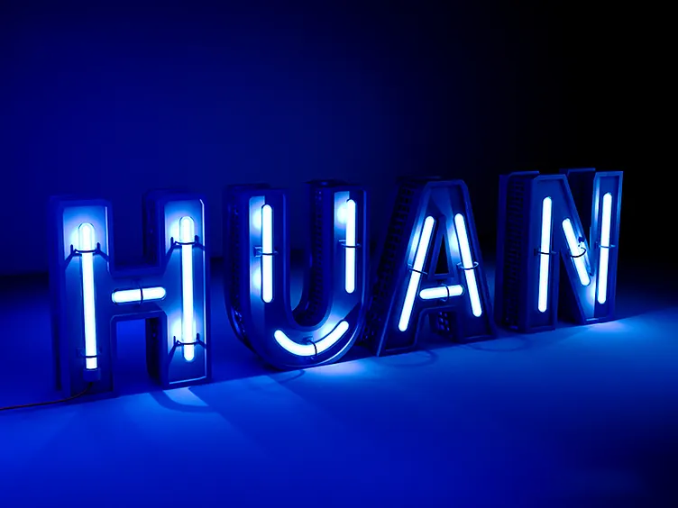 Blue neon HUAN sign
